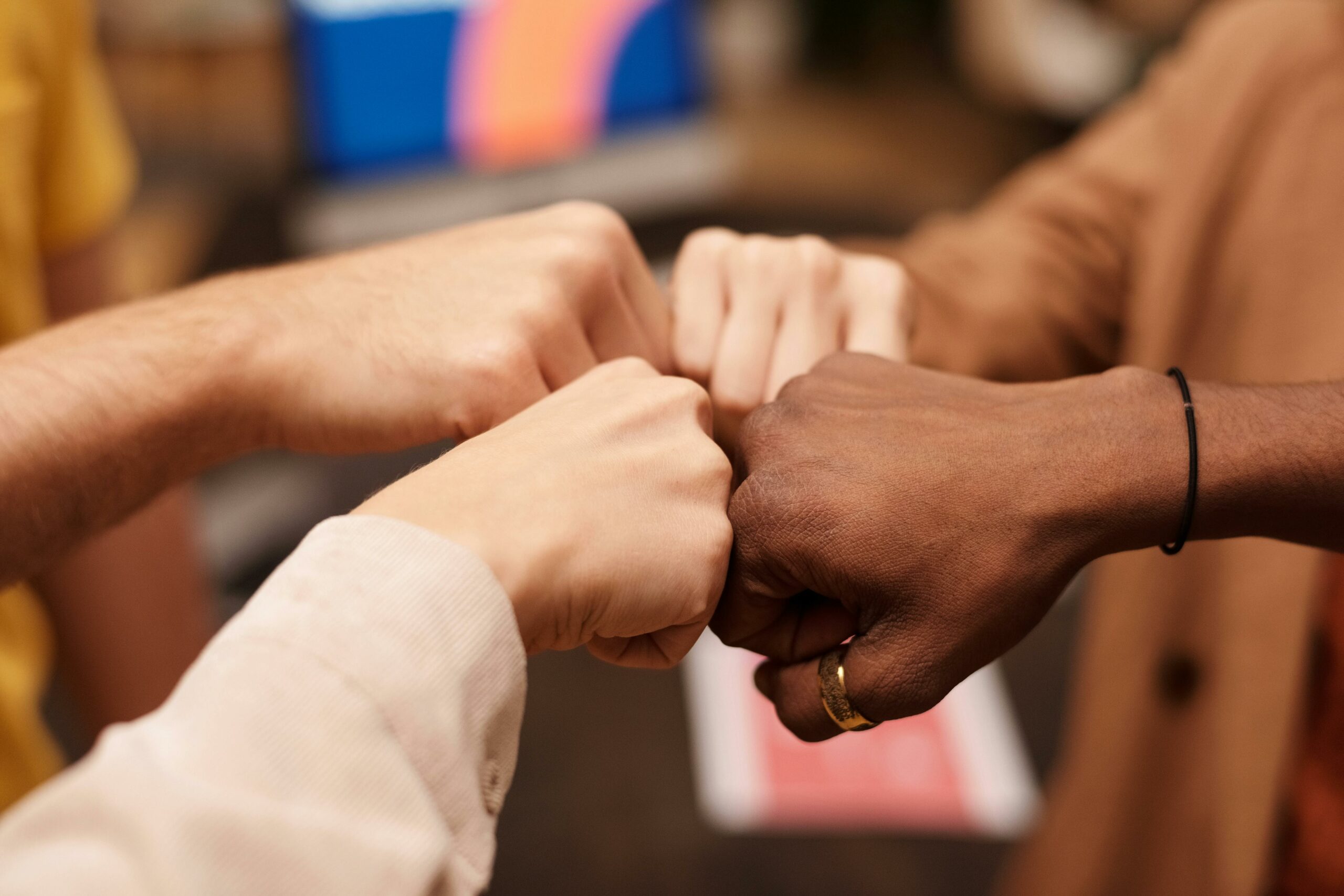 social justice nonprofit finance staff put their fists together because they've got this